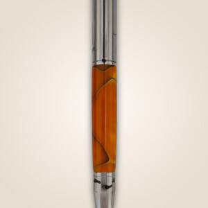 Orange pen with a cross on a silver topping.